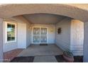 Inviting front entrance featuring a decorative security gate and a well-lit covered entryway at 14909 W Alpaca Dr, Sun City West, AZ 85375