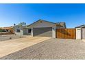 View of the home's front exterior, showcasing the garage, driveway, and rock landscaping at 15028 N 35Th Ave, Phoenix, AZ 85053