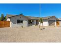 A well-maintained front yard features easy-care rock landscaping, a healthy tree, and privacy at 15028 N 35Th Ave, Phoenix, AZ 85053