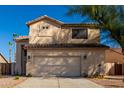 A close-up of a two-story home featuring a two car garage and neutral colored stucco at 16189 N 137Th Dr, Surprise, AZ 85374