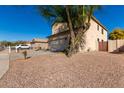 Side view of tan colored two-story home with desert landscaping at 16189 N 137Th Dr, Surprise, AZ 85374