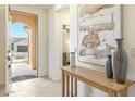 Bright entryway with tiled floors, a console table, and an arched doorway at 16372 W Mulberry Dr, Goodyear, AZ 85395