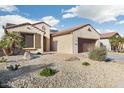 Single-story home showcasing desert-style landscaping, a tile roof, and a private two car garage at 16372 W Mulberry Dr, Goodyear, AZ 85395