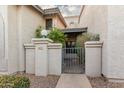 Charming courtyard entrance with secure gate and meticulously maintained stucco facade at 1718 S Longmore -- # 41, Mesa, AZ 85202
