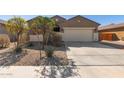 Inviting one-story home featuring a two-car garage, desert landscaping, and a welcoming front entrance at 17583 W Paraiso Dr, Surprise, AZ 85387