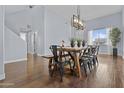 Bright dining room featuring hardwood floors, a farmhouse table, and ample space at 1812 W Kuralt Dr, Anthem, AZ 85086