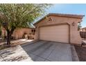 Driveway to a large 2 car garage with desert landscaping at 19405 W Oregon Ave, Litchfield Park, AZ 85340