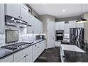 Gourmet kitchen featuring white cabinets, sleek countertops, stainless steel appliances, and ample counter space at 2034 N Dome Rock --, Mesa, AZ 85207