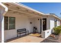 Inviting covered front porch features a bench, potted plants, and desert landscaping at 2902 E Avalon Dr, Phoenix, AZ 85016
