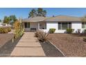 Quaint single story home with a well manicured front yard with desert landscaping at 2902 E Avalon Dr, Phoenix, AZ 85016