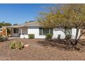 Modest single story home with desert landscaping and mature shade trees at 2902 E Avalon Dr, Phoenix, AZ 85016
