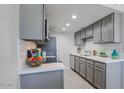 Bright kitchen features white countertops, subway tile backsplash, and modern gray cabinets at 3402 N 32Nd St # 118, Phoenix, AZ 85018