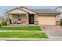 Inviting single-story home featuring a covered porch, stone accents, and a two-car garage at 3563 E Austin Dr, Gilbert, AZ 85296