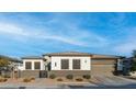 Inviting home featuring a well-maintained lawn, attached garage, and classic design elements for comfortable suburban living at 40195 N Hailey Ln, Queen Creek, AZ 85140