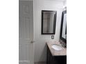 Features a granite vanity top and tile shower, and includes a white door and decorative mirror at 4436 E Pueblo E Ave, Phoenix, AZ 85040
