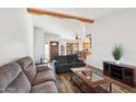 The living room showcases wood laminate flooring and an open layout to the dining area at 4530 W Continental Dr, Glendale, AZ 85308
