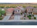 Aerial view of a two-story home featuring a tile roof, desert landscaping, and a two-car garage at 4535 W Cottontail Rd, Phoenix, AZ 85086