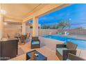 A serene backyard oasis featuring a swimming pool with an integrated spa and a shaded patio at 4535 W Cottontail Rd, Phoenix, AZ 85086