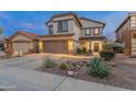 Two-story home featuring a tidy desert rock garden, a two-car garage, and well-kept landscaping at 4535 W Cottontail Rd, Phoenix, AZ 85086