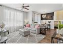 Bright living room with a comfortable gray sofa, decorative pillows, and view to dining space at 5303 N 7Th St # 215, Phoenix, AZ 85014