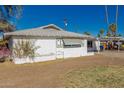 Side view of a white single-story home featuring a white roof and well-kept landscaping at 638 W 16Th St, Tempe, AZ 85281