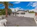 Charming home featuring a modern garage door, fresh white paint and desert landscaping at 6926 E Moreland St, Scottsdale, AZ 85257