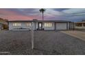 Inviting single-story home with well-kept desert landscaping, a garage, and convenient covered parking at 934 S Roslyn Pl, Mesa, AZ 85208