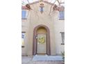 Arched front entryway features a decorative wreath, screen door, and covered porch at 1349 E Dunbar Dr, Phoenix, AZ 85042