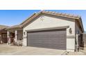 Lovely front exterior showcasing attached garage, low maintenance desert landscaping, and covered porch at 1366 W Santa Gertrudis Trl, San Tan Valley, AZ 85143