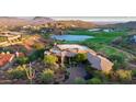Aerial view of a home situated on a sprawling lot near a golf course and lake at 15827 E Firerock County Club Dr, Fountain Hills, AZ 85268