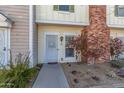 Charming townhome featuring a walkway to the front door, mature shrubbery, and red brick details at 1601 N Saba St # 264, Chandler, AZ 85225