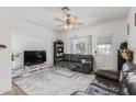 Comfortable living room with ceiling fan, neutral walls, and plush gray rug with modern furniture at 1601 N Saba St # 264, Chandler, AZ 85225