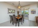 Cozy dining room with seating for six, a mirror, and sliding glass doors to the patio at 16495 W Monteverde Ln, Surprise, AZ 85374