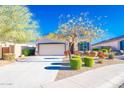 Beautiful single-story home boasts manicured landscaping and a two car garage in a friendly neighborhood at 17563 W Summit Dr, Goodyear, AZ 85338