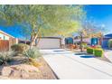 Attractive single-story home with a desert landscaped front yard and a two car garage at 17563 W Summit Dr, Goodyear, AZ 85338