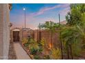 Cozy side yard featuring garden bed, brick wall, and a wooden gate at 1835 E Bartlett Pl, Chandler, AZ 85249