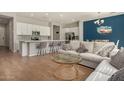 Spacious living room and kitchen with counter seating, white cabinets, stainless appliances, and open floorplan at 1941 W Trotter Trl, Phoenix, AZ 85085
