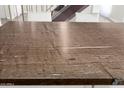 Close-up of a dining table featuring a granite countertop with a unique wood grain pattern, and modern chairs at 2 W Georgia Ave # 5, Phoenix, AZ 85013
