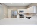 Bright kitchen featuring stainless steel appliances, modern countertops and ample cabinet space at 2051 W Ronald Rd, Phoenix, AZ 85029