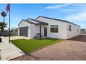 Home exterior showcasing a gray roof, nice lawn, and exterior bench near the front door at 2250 S Descanso Rd, Apache Junction, AZ 85119