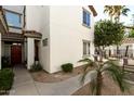 Well-maintained exterior showcasing stucco facade, tile roof, and charming desert landscaping at 2992 N Miller Rd # 219B, Scottsdale, AZ 85251