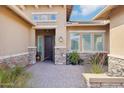 Inviting front entry with a stone-accented facade and brick walkway, great curb appeal at 31626 N 129Th Dr, Peoria, AZ 85383