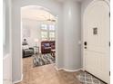 Light-filled entryway transitions into the living area featuring tile floors and neutral walls at 32405 N 23Rd Ave, Phoenix, AZ 85085