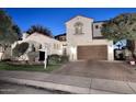 Stately two-story home with a brick driveway, two car garage, and terra cotta roof offers great curb appeal at 3370 S Ivy Way, Chandler, AZ 85248