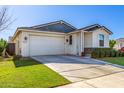 Inviting single-Gathering home with a manicured lawn, two-car garage and easy street access at 35212 N Magnette Way, San Tan Valley, AZ 85144