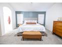 Serene main bedroom with accent wall, plush carpet, and a comfortable bed at 41250 W Thornberry Ln, Maricopa, AZ 85138