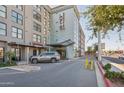 Well-maintained apartment building exterior with covered entrance, landscaping, and parking area at 535 W Thomas Rd # 207, Phoenix, AZ 85013