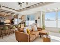 Comfortable living area with a brown sectional, open kitchen, tile floors, and track lighting at 535 W Thomas Rd # 207, Phoenix, AZ 85013