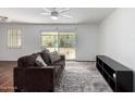 Bright living room featuring wood floors, a patterned rug, and large windows at 7327 N 21St Ave, Phoenix, AZ 85021