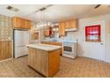 Kitchen with an island and white appliances at 8648 N 37Th Ave, Phoenix, AZ 85051